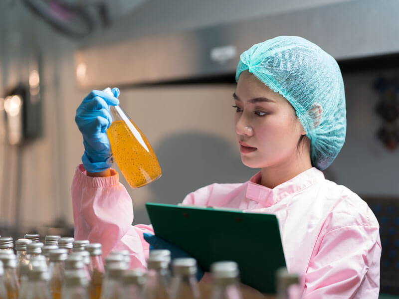 registered dietitian inspecting product bottles for quality control