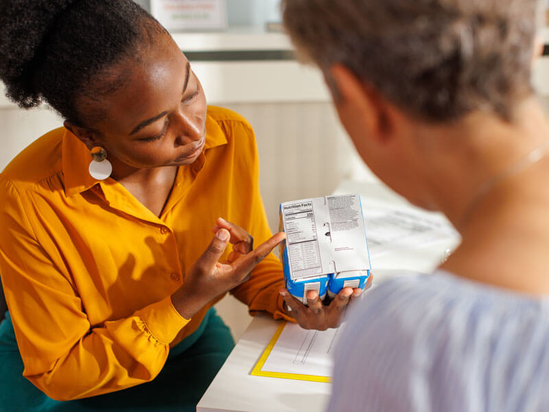 nutritionist reviewing with her client a nutrition facts label